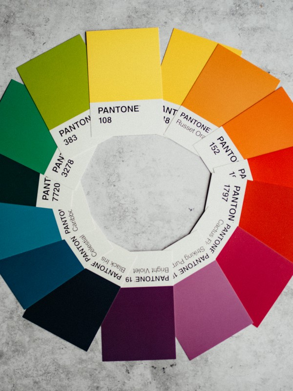 different pantone cards of several colours arranged as the colour wheel