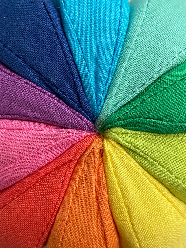 colorful fabrics arranged in a way to create the colour wheel